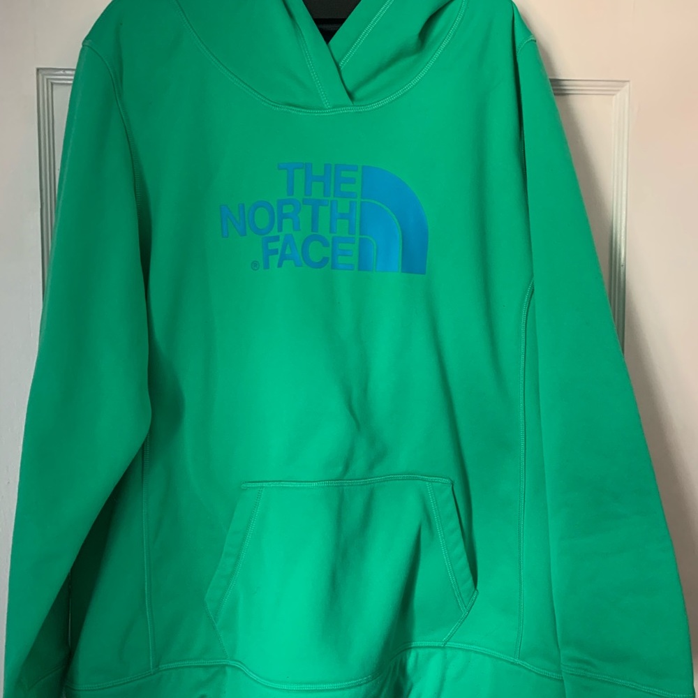 Green and blue women’s North Face sweatshirt